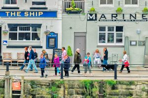 People walking along a waterfront.