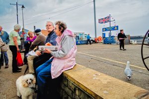 People enjoying snacks by the seaside.