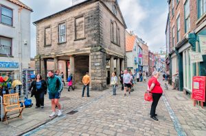 Historic street with people walking.